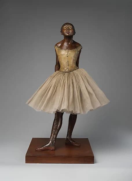 The Little Fourteen-Year-Old Dancer by Edgar Degas, modeled 1881, cast 1922, modern tutu. Partially tinted bronze, cotton tarlatan, silk satin, and wood. Image from The Metropolitan Museum of Art.